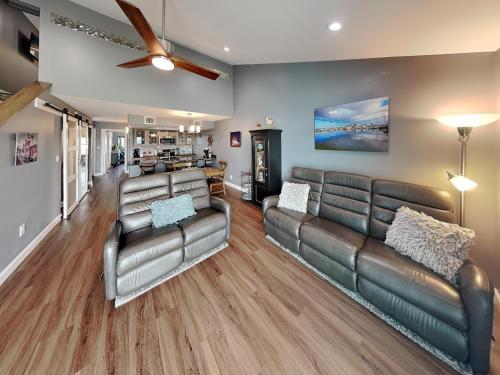 a living room with leather furniture and a ceiling fan at Kontiki Bayfront Condo #710 in Rockport