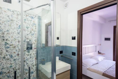 a bathroom with a shower and a sink at Zenia Rooms in San Teodoro