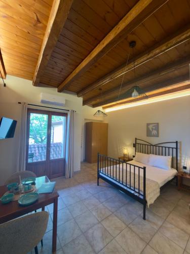 a bedroom with a bed and a wooden ceiling at Kyriakos Apartments in Politika