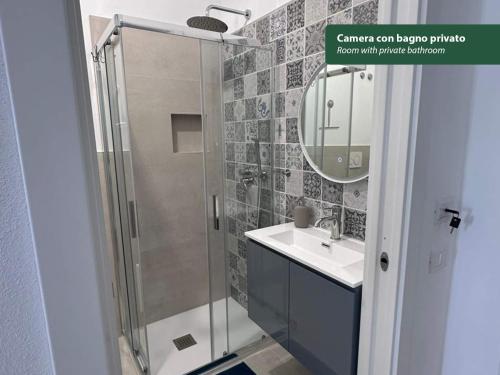 a bathroom with a shower and a sink and a mirror at Isola Chiara in Cagliari