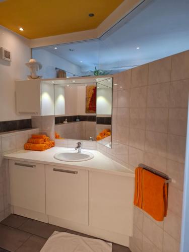 a bathroom with a sink and a mirror at Ferienwohnung Lienz Egger in Lienz