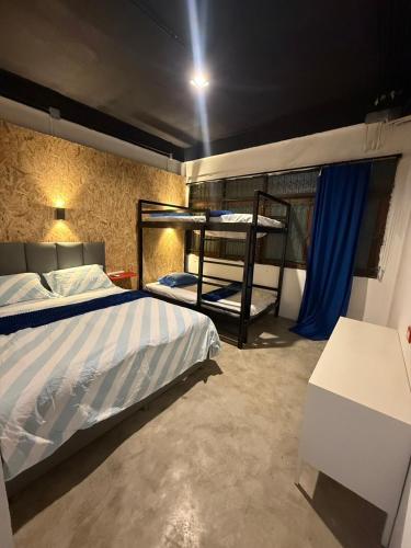 a bedroom with a bed and bunk beds in it at MAXi MaMa Room in Bangkok
