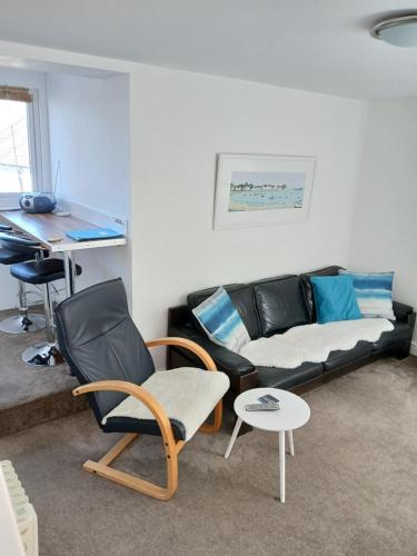 a living room with a couch and a table at Uwch Menai in Y Felinheli