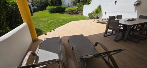 a patio with a table and chairs on a deck at 7 Ocean Point in Sitio de Calahonda