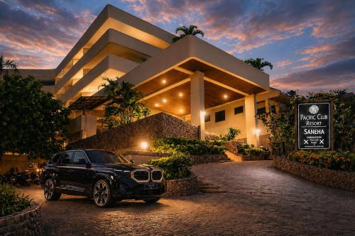 a black car parked in front of a building at Pacific Club Resort in Karon Beach