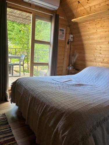 a bedroom with a bed and a large window at U Sognu 3128 in Muro