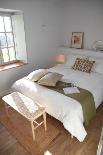 a bedroom with a bed with a table and a chair at Villa Casalís in Cubas