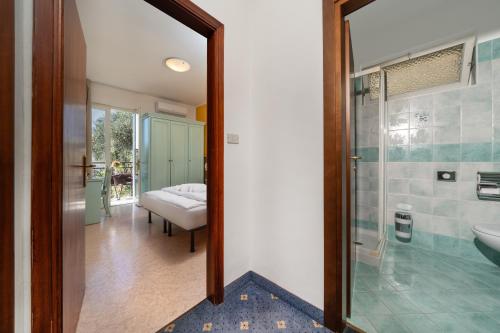 a bathroom with a shower and a sink and a mirror at Hotel Silvana Garnì in Limone sul Garda