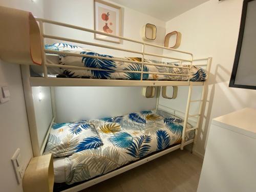 a room with three bunk beds in a room at La Grange de Céor in Cassagnes-Bégonhès