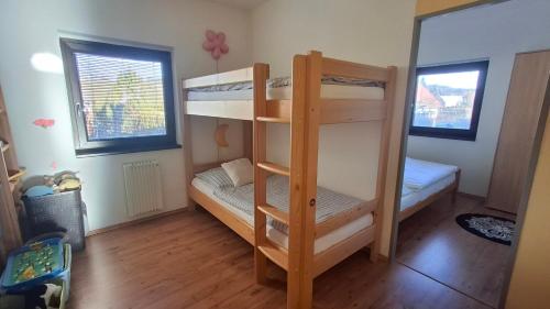 a bunk bed room with two bunk beds in it at Bungalov pod Lípami in Mladějov