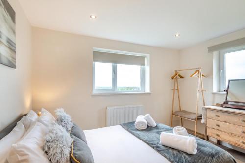 a bedroom with a bed and a tv and a window at 3 Bed in Belford oc-79178 in Belford