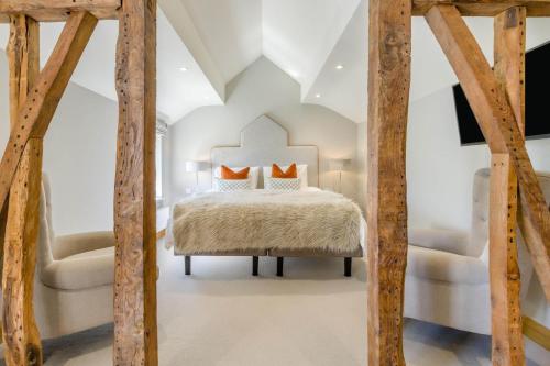 a bedroom with a bed and two chairs at 3 Bed in Hereford oc-83659 in Madley