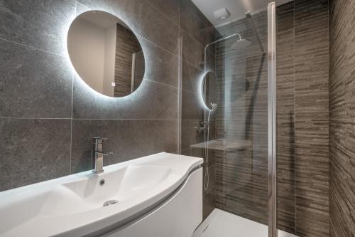 a bathroom with a white sink and a mirror at violette in Pornichet