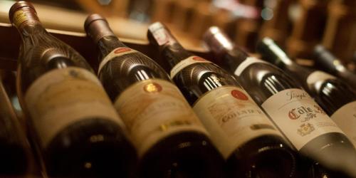 a bunch of wine bottles lined up in a row at Pousada Les Roches in Itaipava