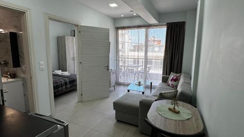 a living room with a couch and a table at Bella Luxury Suite III in Paralia Katerinis