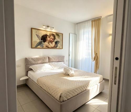 a bedroom with a bed with a picture on the wall at Marco Polo House in Chioggia