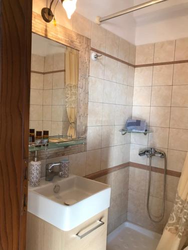 a bathroom with a sink and a shower at Niriides in Ammouliani