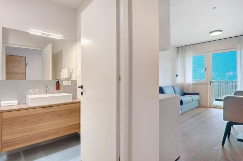 a bathroom with a sink and a toilet in a room at Gisshübelhof Apartments in Lana