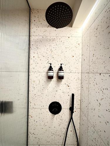 a bathroom with two bottles on the wall at Mont-Blanc Design Studio in Morgex