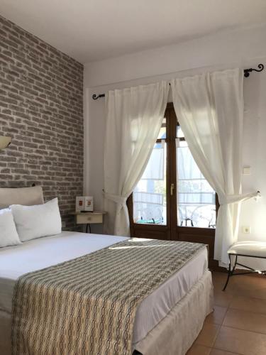 a bedroom with a large bed and a window at Niriides in Ammouliani