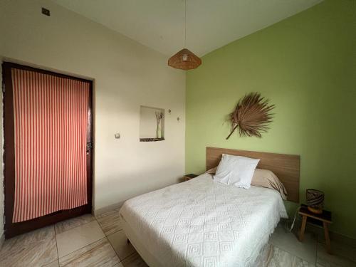 a bedroom with a bed and a red door at Casa Tota in Assomada