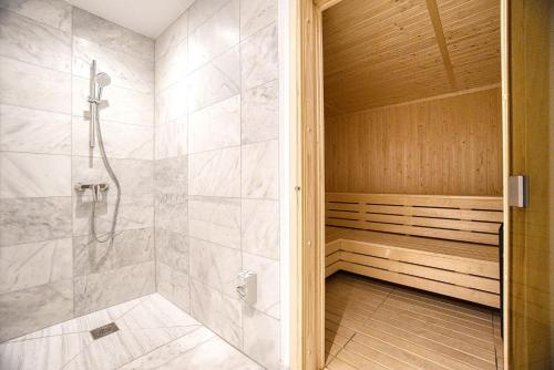 a bathroom with a walk in shower and a walk in shower at Modern Sea-View Work Apartment, Sit-Stand Desk, Pool, Gym & Walk to Old Town in Paphos
