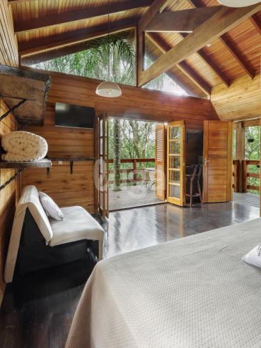 a bedroom with a bed in a room with wooden walls at Suite Low – Cyclists' Paradise in Gramado