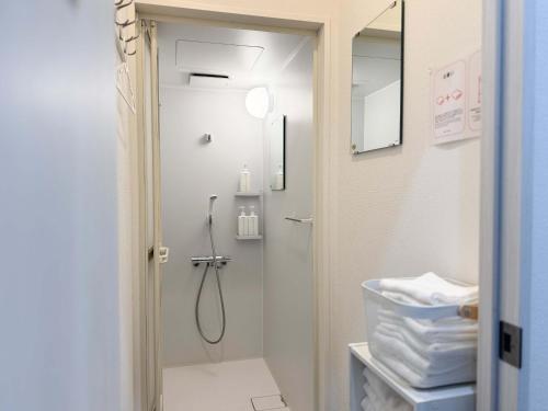 a bathroom with a shower with a shower head at D旅館　Dryokan in Tokyo
