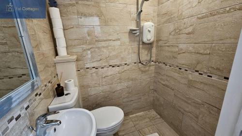 a bathroom with a toilet and a sink at The Summer House in Saint Mawes