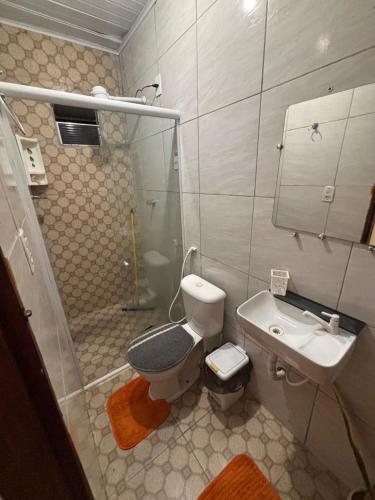 a bathroom with a shower and a toilet and a sink at Casa de temporada 08 Pessoas PISCINA LAZER Entretenimento pra família in João Pessoa
