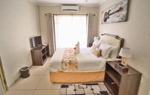 a bedroom with a large bed and a window at Hillview inn hotel in Serowe