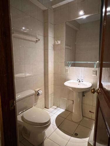 a bathroom with a toilet and a sink at Killaqente in Cusco