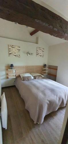 a bedroom with a large bed in a room at La Maison du Cros in Cassagnes-Bégonhès