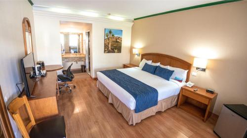a hotel room with a bed and a desk at Las Misiones Hotel in Monclova