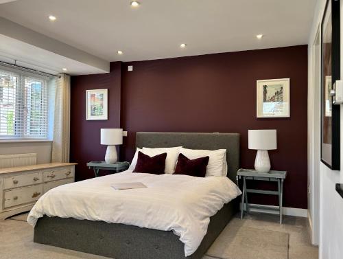 a bedroom with a large bed and two night stands at THE STUDIO MAIDENHEAD RIVERSIDE in Maidenhead