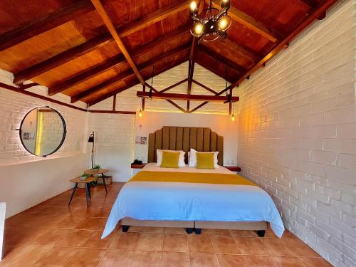 a bedroom with a large bed in a brick wall at Monte Selva Hotel Spa Termal in Baños