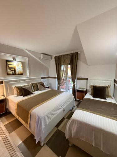 a bedroom with two beds and a window at Grand Apartments Scepanovic in Tivat