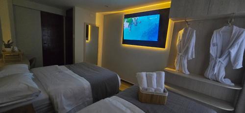 a hotel room with two beds and a flat screen tv at HB Selection Hotel in Miraflores