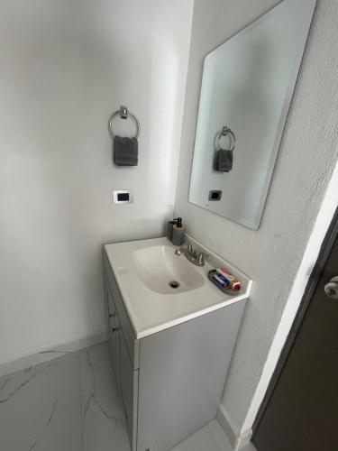 a white bathroom with a sink and a mirror at El Retiro Villas & Pádel - Villa 3 in Parras de la Fuente