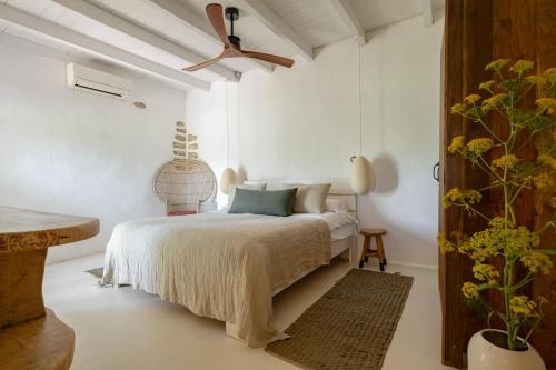a bedroom with a bed and a ceiling fan at Hotel Can Sastre in Santa Gertrudis de Fruitera