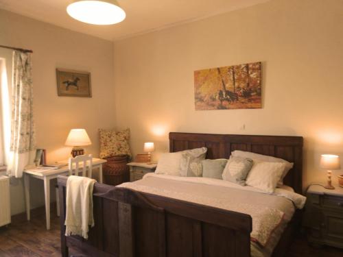 a bedroom with a bed and two tables and a lamp at Studniska Country Estate in Studniska