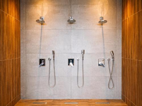 a bathroom with a shower with four shower heads at Caesar Blue Collection Nothern Cyprus Family Bedroom Suites in Ayios Dhometios