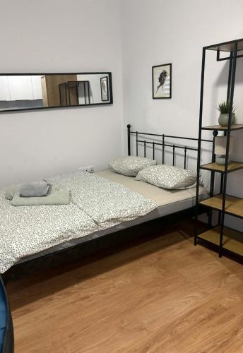 two beds in a room with a mirror at Apartamenty Rybna 1 Centrum in Tarnów