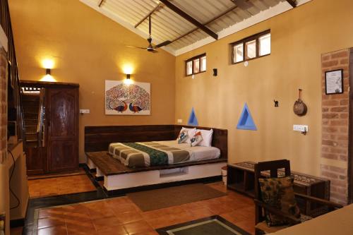 a bedroom with a bed in a room at Surwahi Social Ecoestate Kanha in Kānha