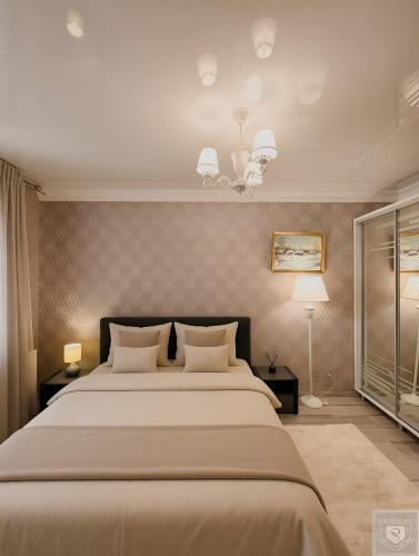 a large bedroom with a large bed with two lamps at RentHouse Apartments Premium Living in Chişinău