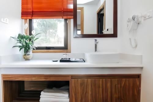 a bathroom with a sink and a mirror at Sea Angel Hotel Halong in Ha Long