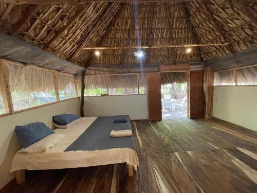 a bedroom in a tent with a bed and a wooden floor at Bokané in Boca del cielo