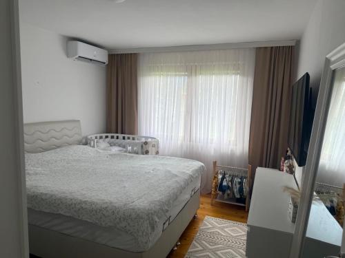 a bedroom with a bed and a window at Butmir house-Sarajevo in Sarajevo
