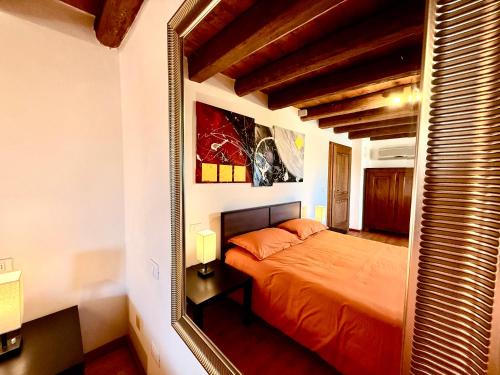 a bedroom with a bed and a large mirror at Villa Saten in Pavia dʼUdine