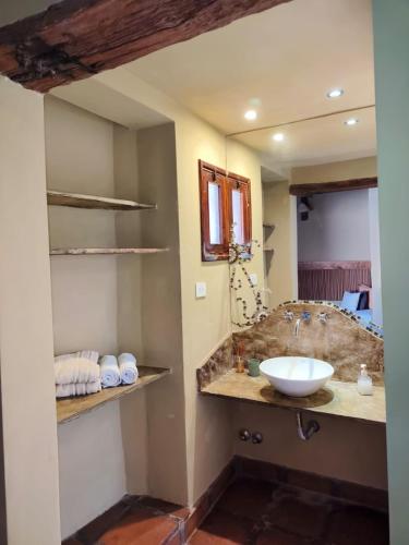 a bathroom with a sink and a mirror at Hotel El Reposo Del Diablo in Tilcara